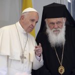 Pope Francis gestures next Archbishop Ieronymos II on the Greek Island of Lesbos